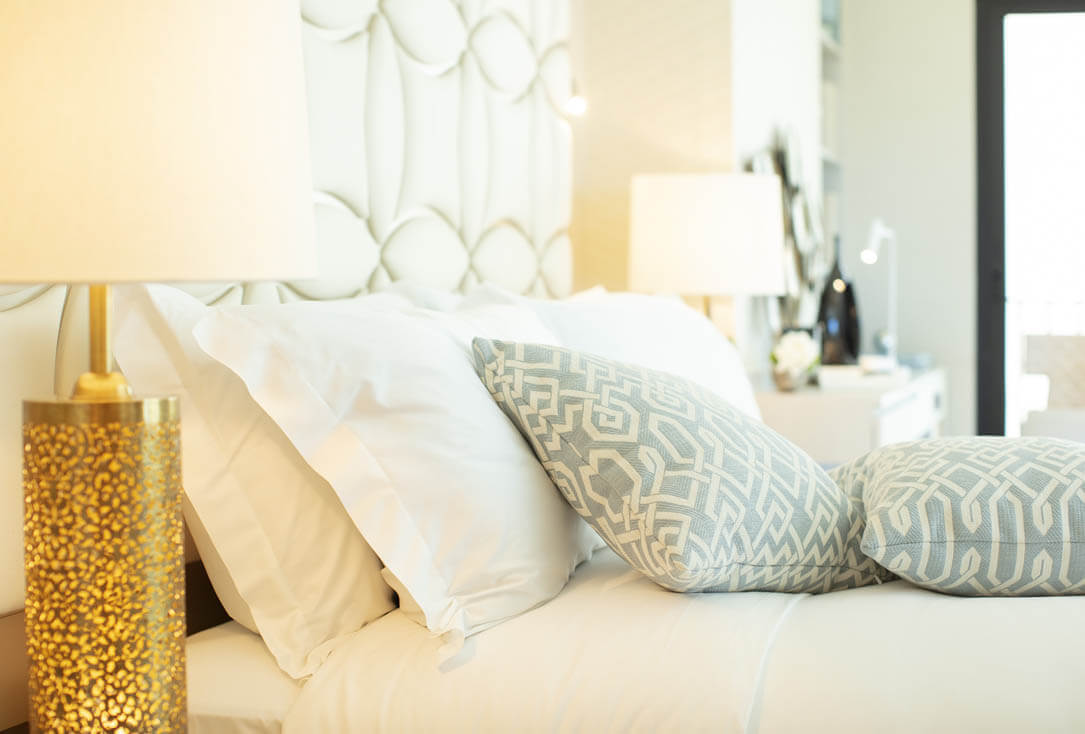 Lamp, bed, pillows.