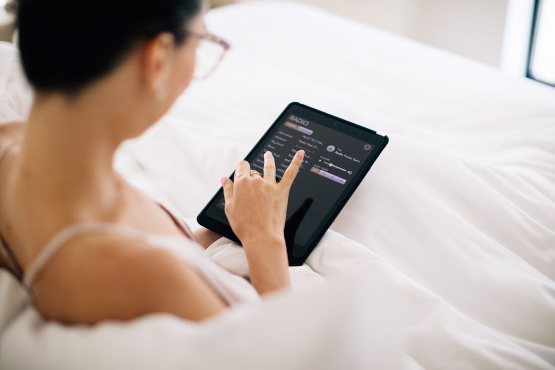 Woman using iPad in bed.