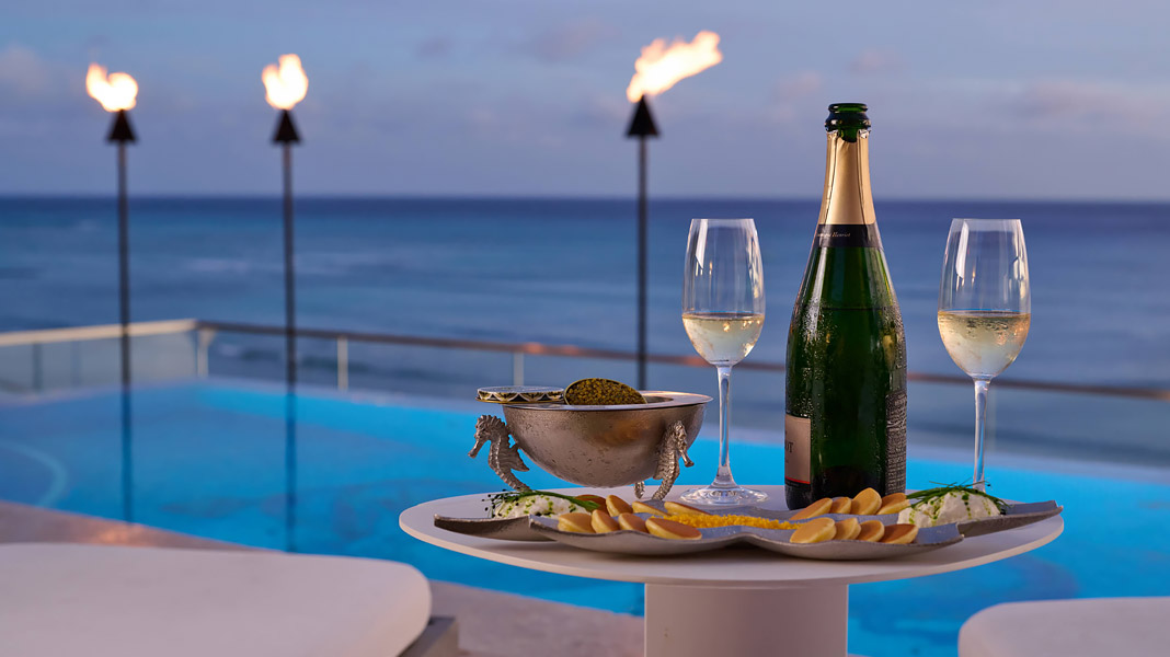 Champagne and caviar served on the rooftop deck at ESPACIO, overlooking the ocean.