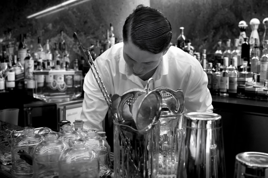 Bartender preparing drinks.