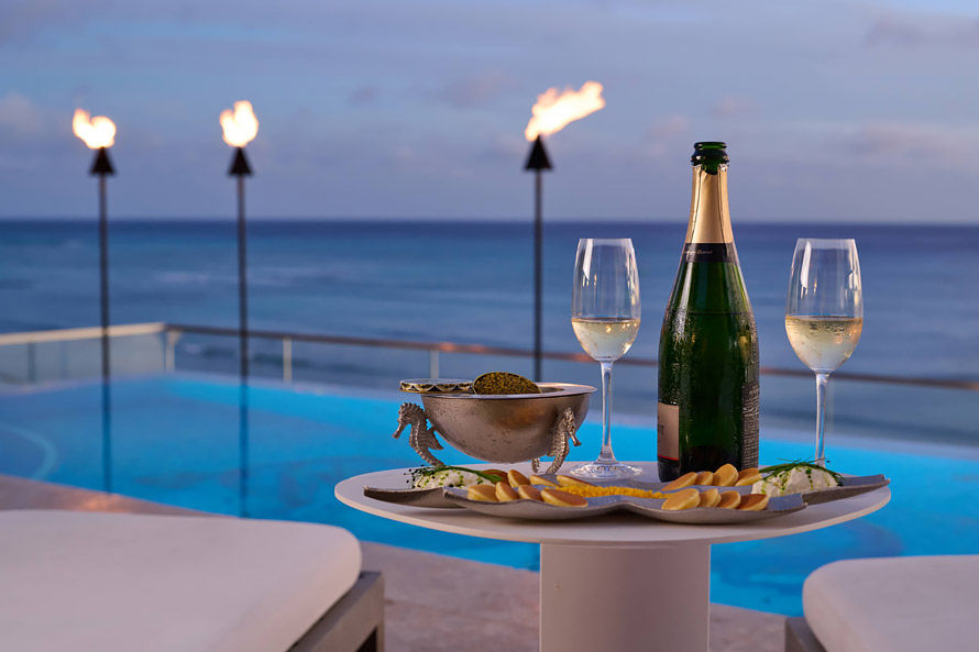 Champagne and caviar served at sunset on the rooftop pool deck.