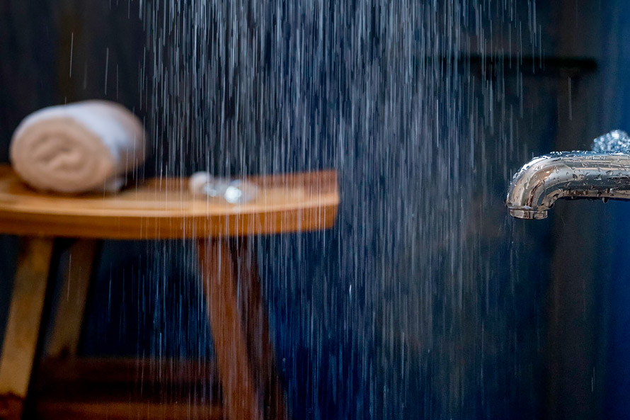 Bathroom with waterfall shower.