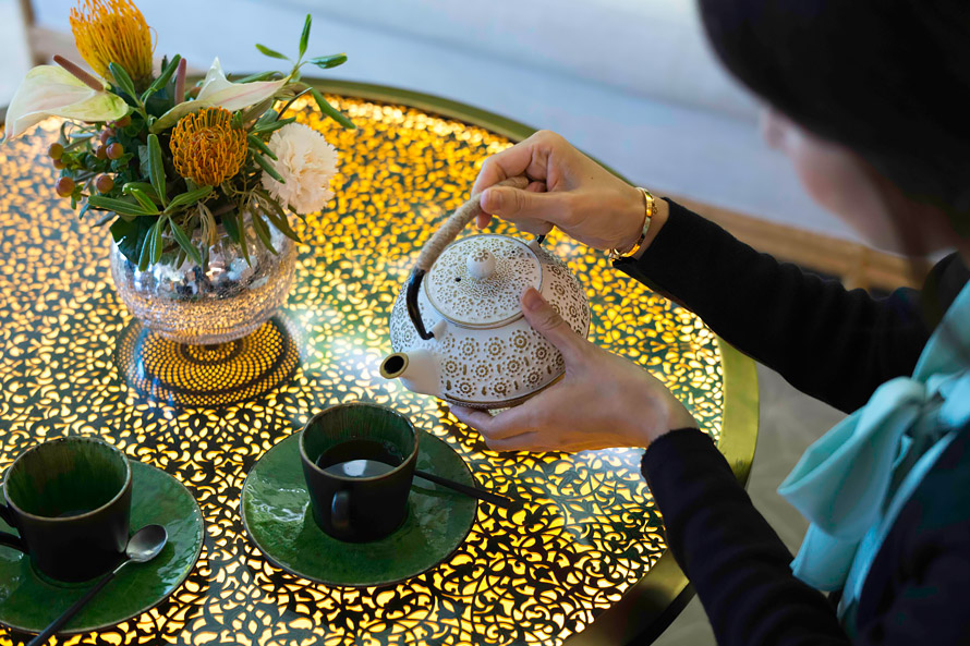 Woman serving Afternoon Tea.