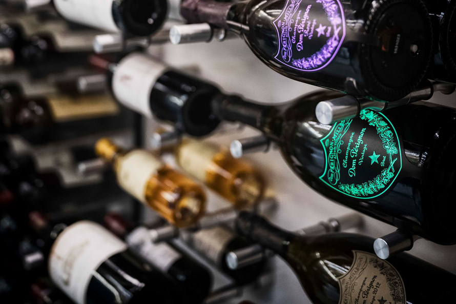 Wine rack with several bottles of Dom Perignon champagne.