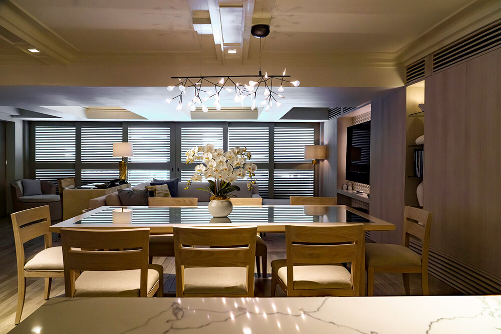 Dining area with chairs, tables, and living room area.